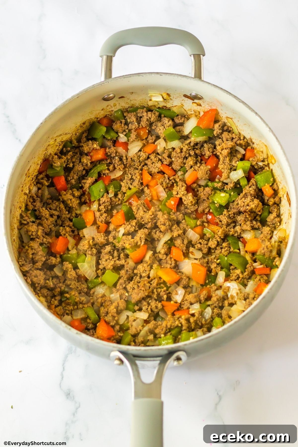 ground beef onions and peppers in a pan