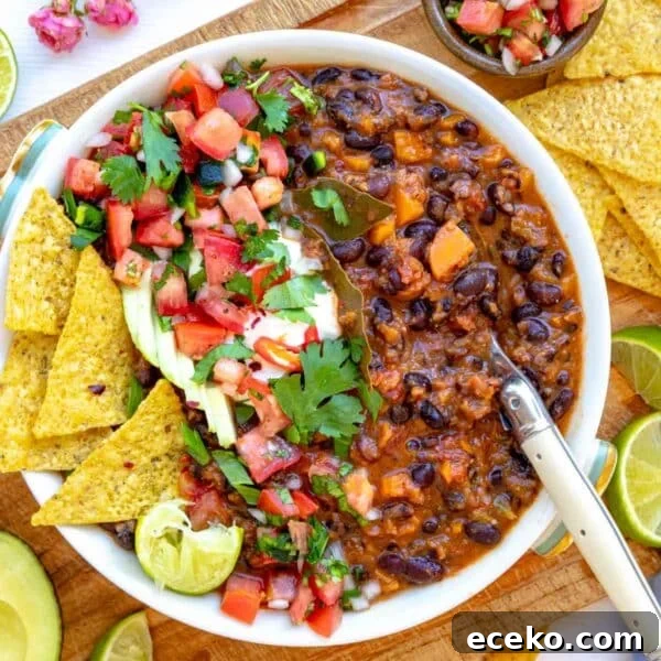 How to Make Tadka: Quick Guide to Tempering Indian Spices 16 Black bean soup in a white bowl as a healthy soup meal.