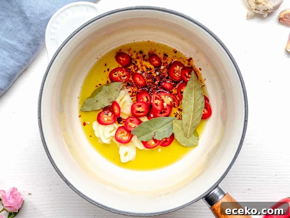 How to Make Tadka: Quick Guide to Tempering Indian Spices 5 making tadka in a saucepan with oil, aromatics and spices