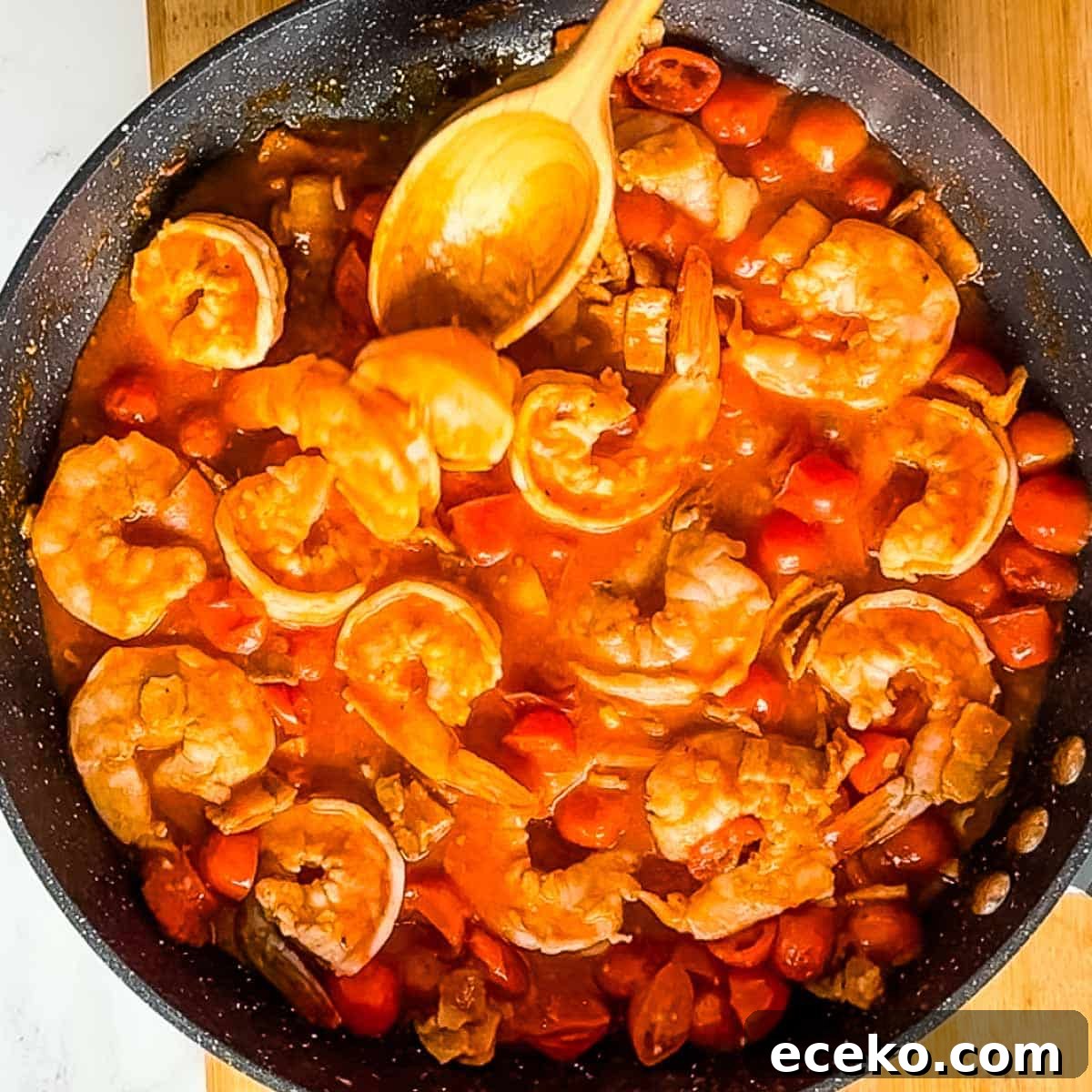 shrimp cooking in bloody mary sauce.