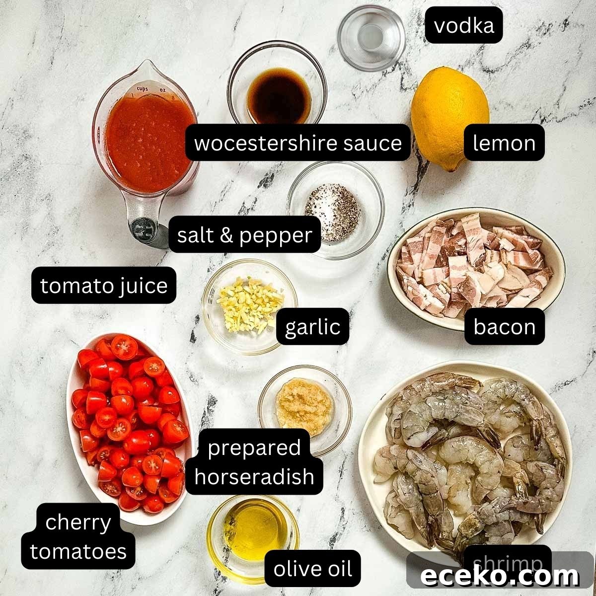 labeled ingredients for bloody mary shrimp on white marble counter.
