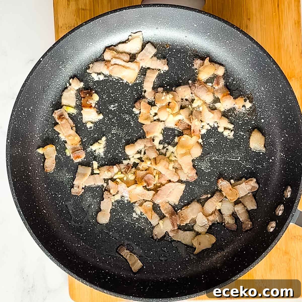 bacon and garlic in frying pan.