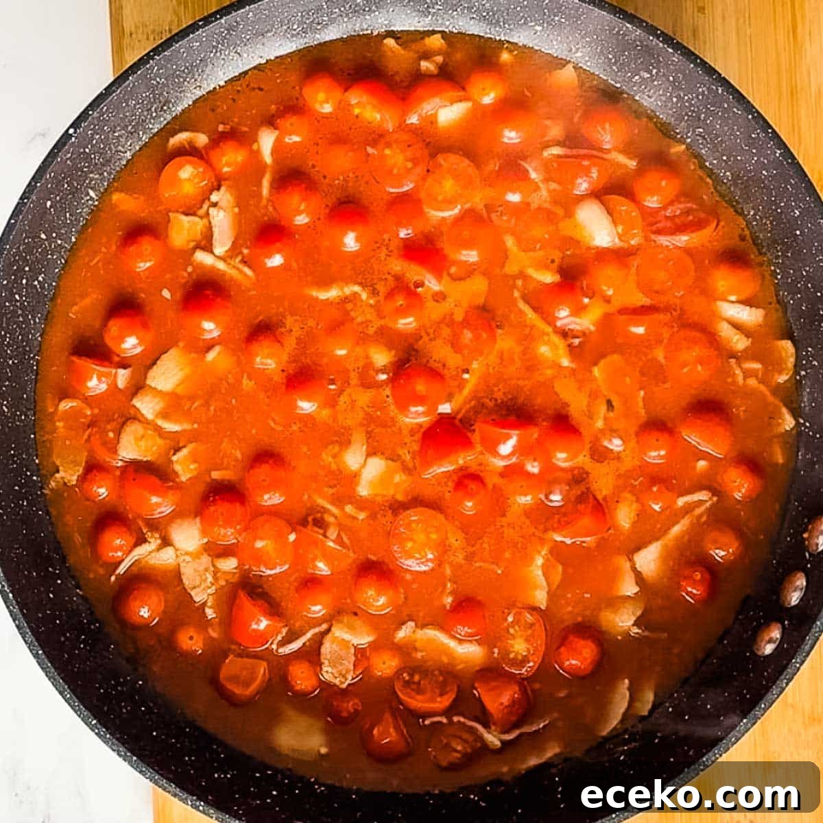 cooking down bloody mary sauce in pan.