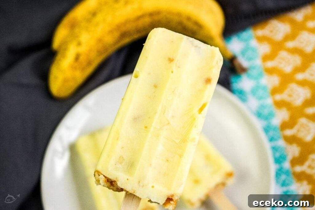 closeup of banana pudding popsicle with a banana in the background
