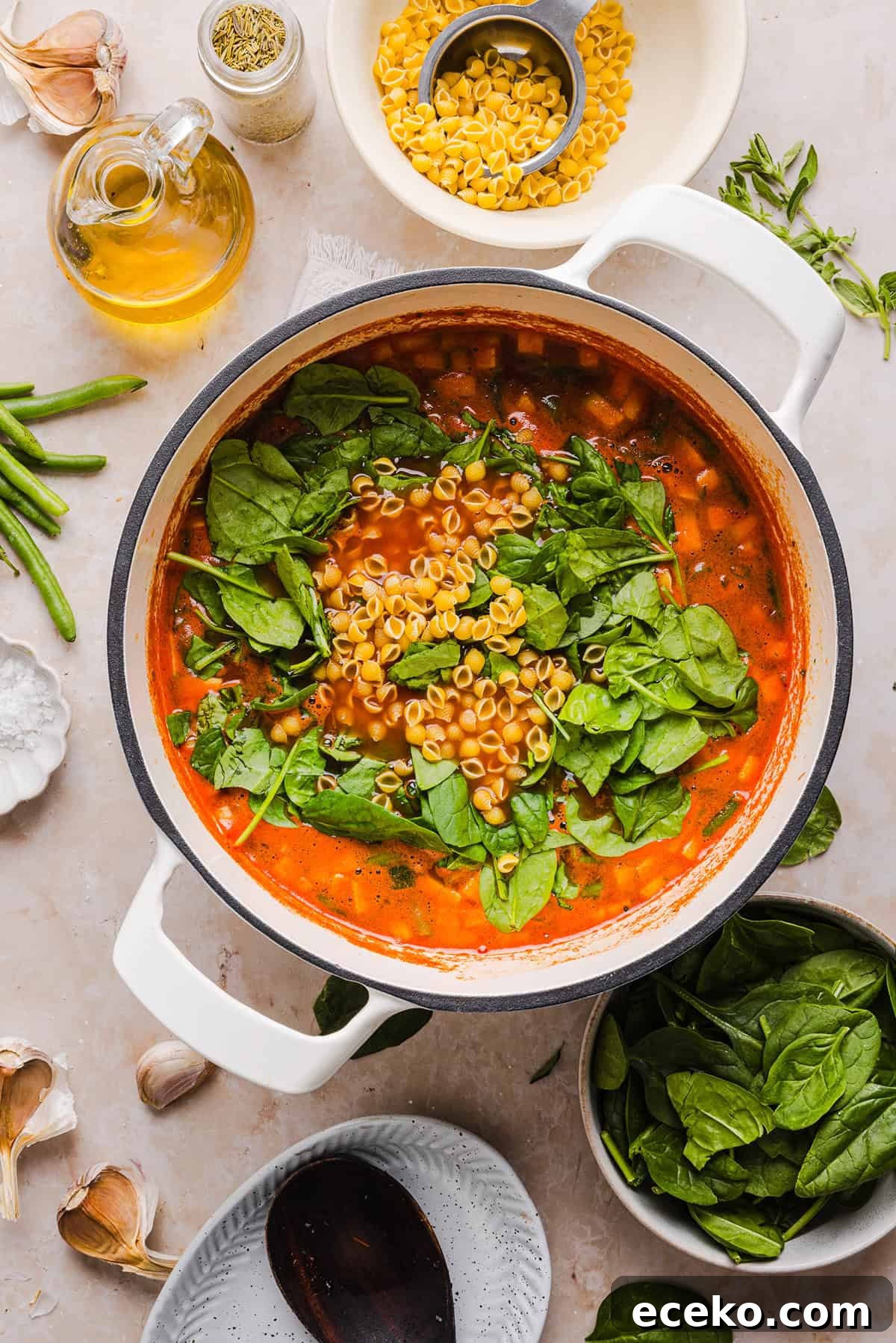 Easy and delicious Olive Garden Minestrone Soup loaded with fresh veggies, leafy greens and simmered in the most flavorful broth! Easily made in one pot for a cozy weeknight dinner the whole family will love!