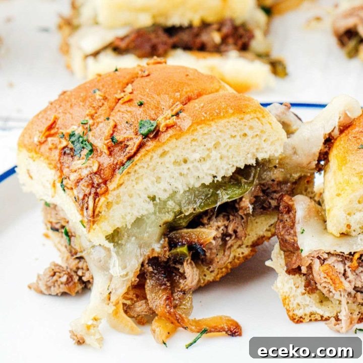 Philly cheesesteak sliders on a plate.