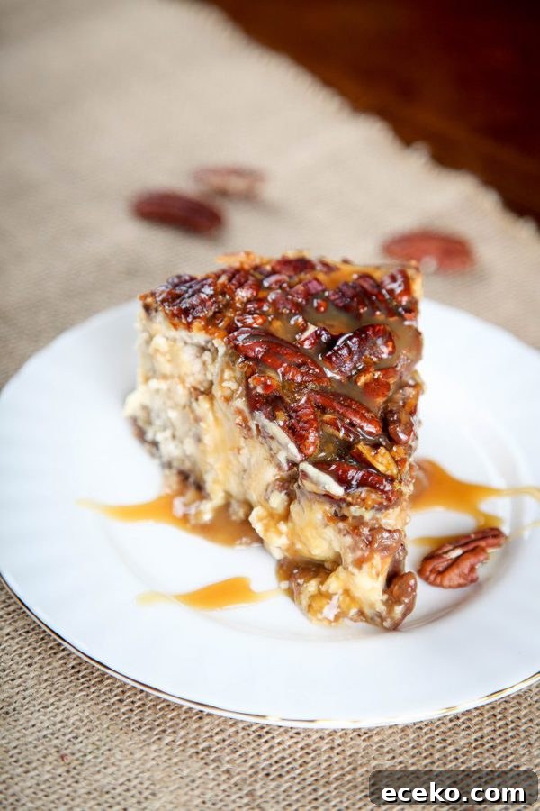 Pecan Pie Cheesecake Recipe: Creamy Layered Pecan Dessert 4 a slice of pecan pie cheesecake topped with caramel on a burlap placemat.