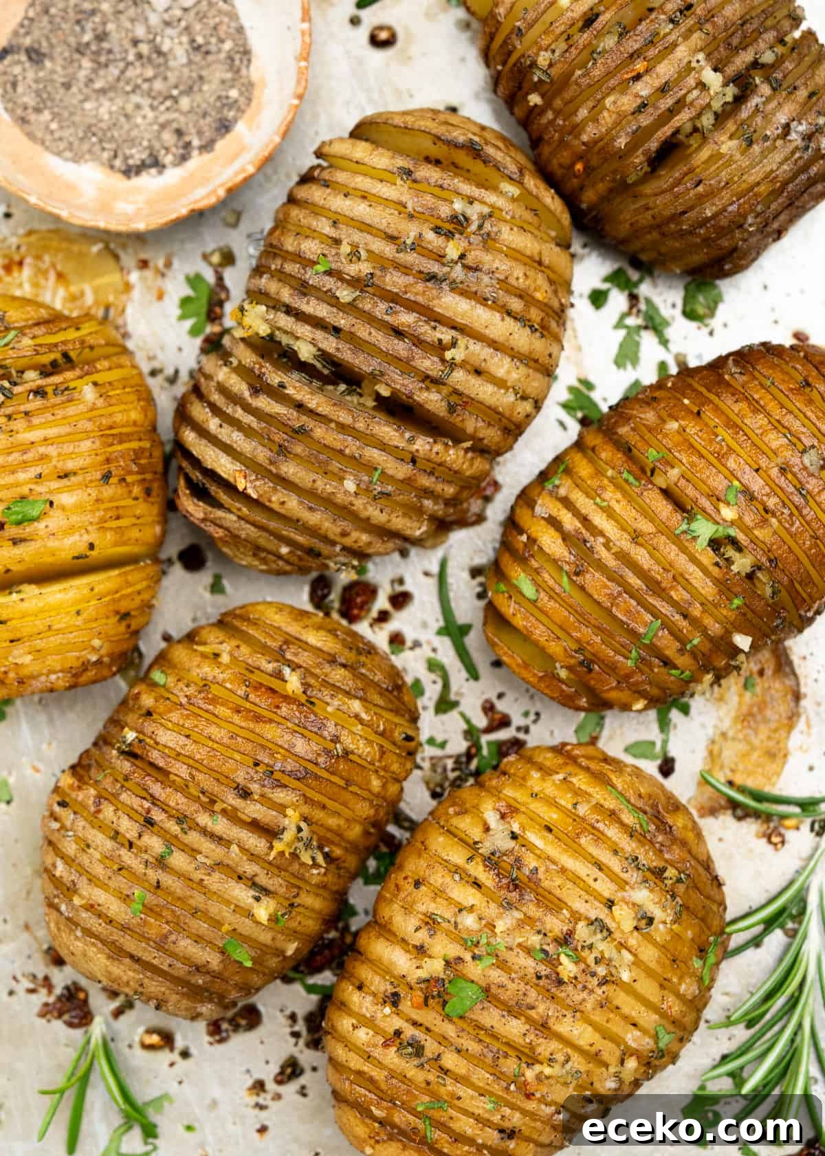Hasselback Potatoes are a fun way to serve baked potatoes. Potatoes are sliced thin, flavoured with garlic rosemary butter, then baked until they are crispy on the outside and cooked perfectly on the inside. 