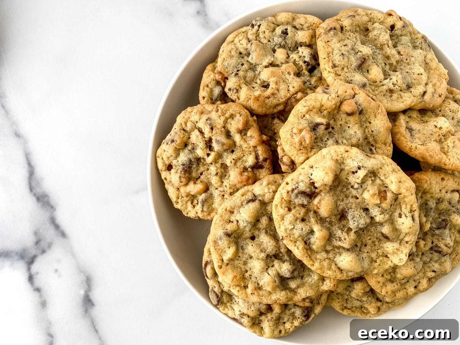 A bowl loaded with baked chocolate chip cookies.