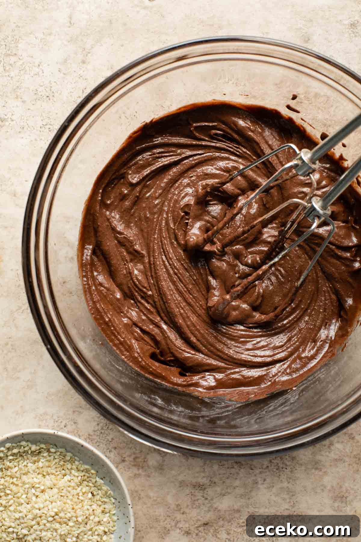 Chocolate tahini frosting in a glass bowl.