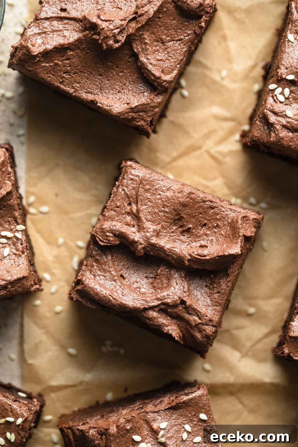 Close up overhead view of a brownie topped with chocolate frosting.