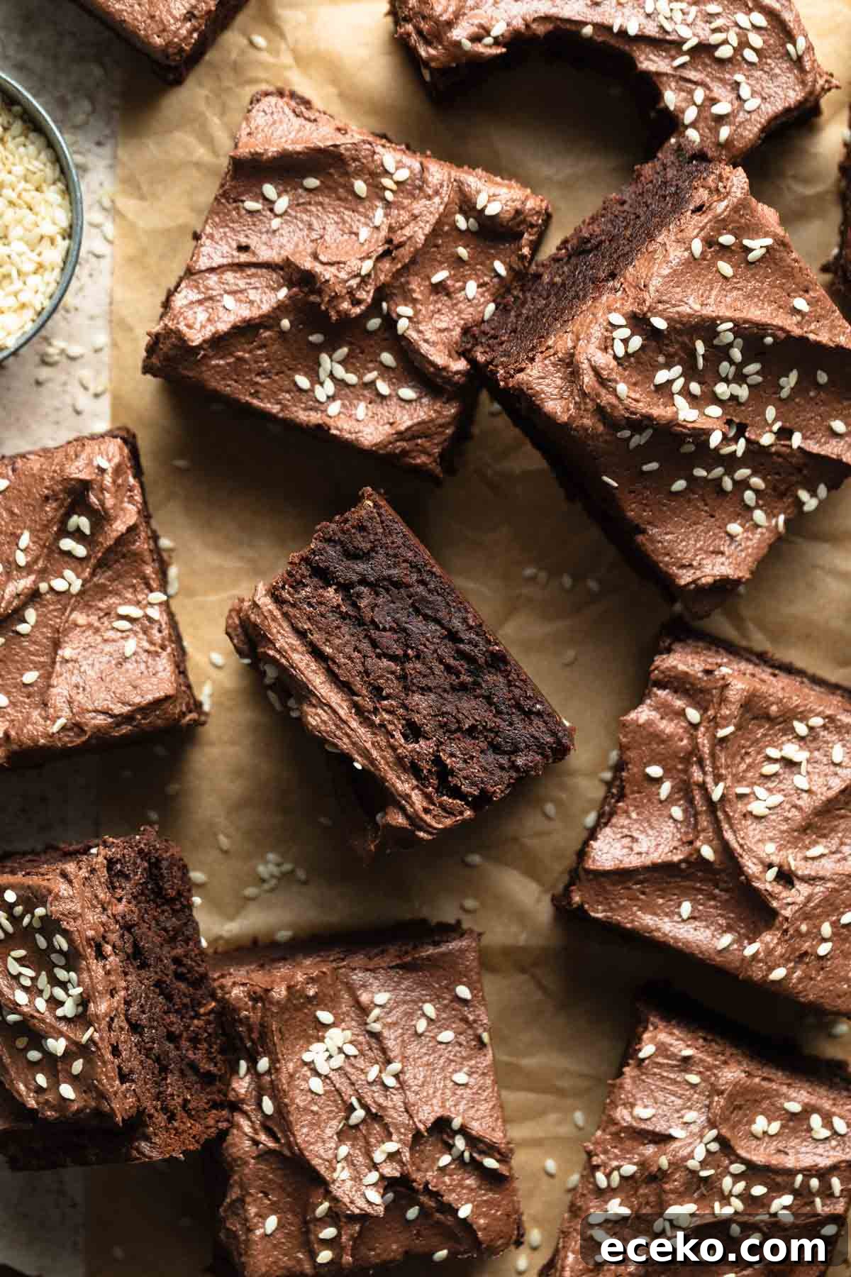 Tahini brownies arranged on brown parchment paper.