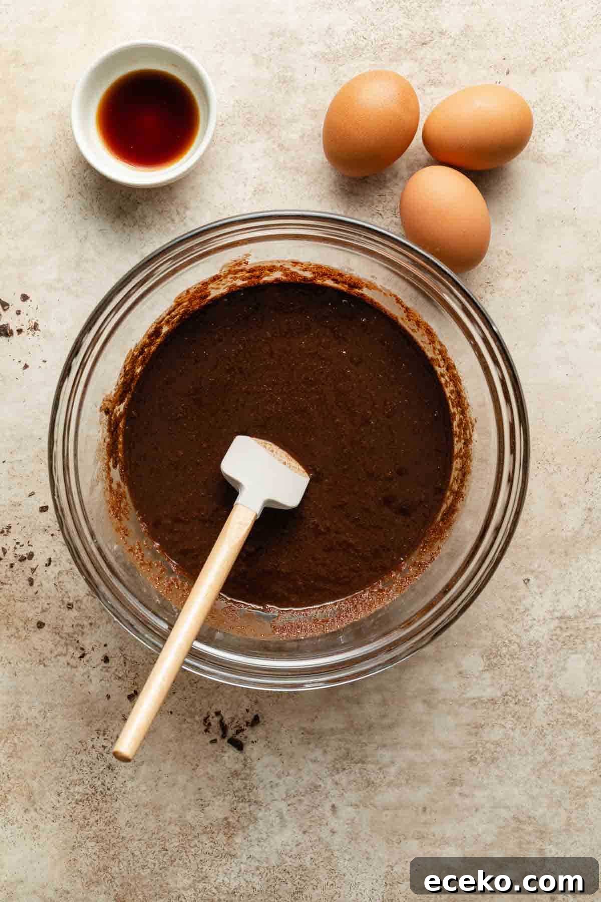Melted chocolate and sugar mixed together in a glass bowl.