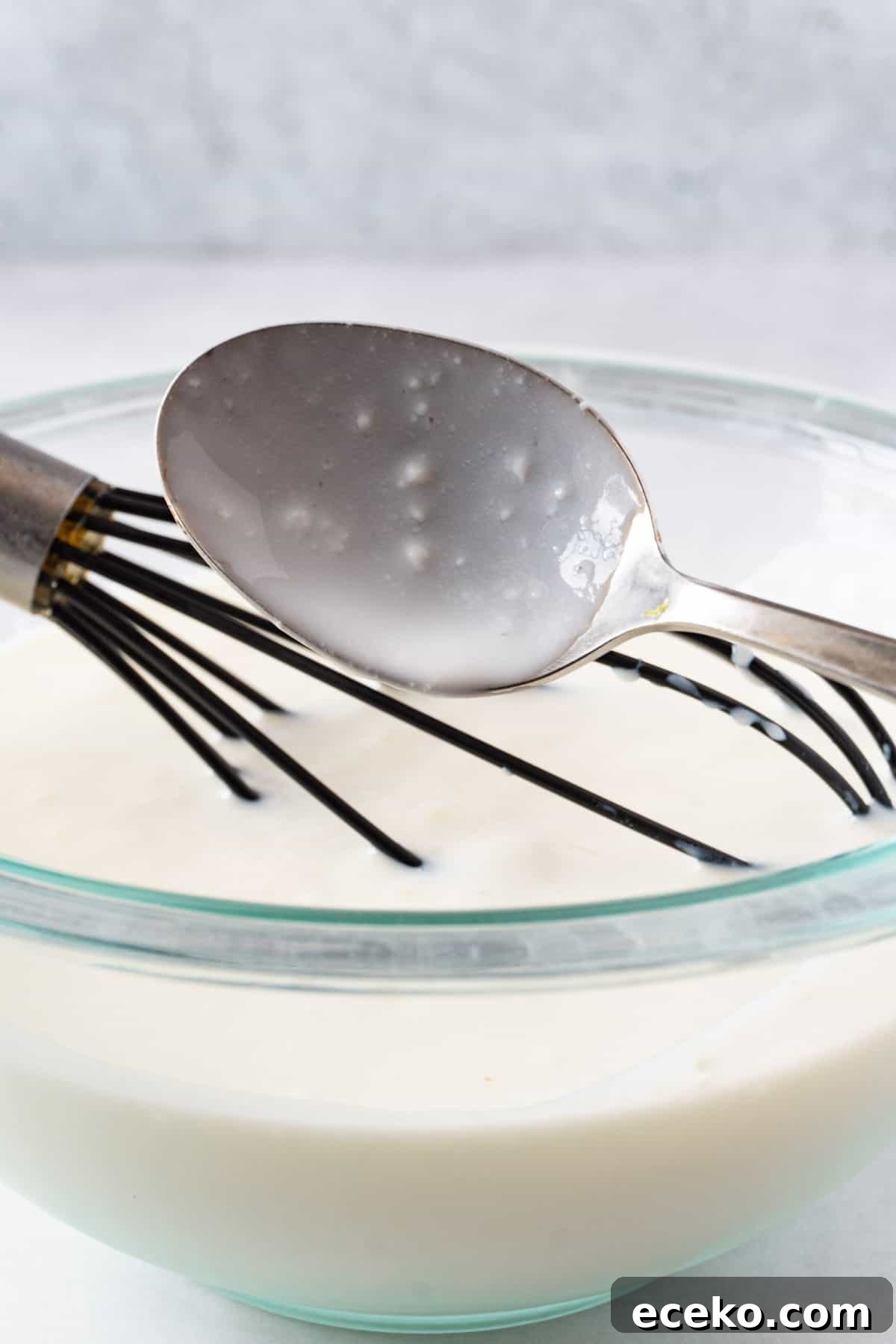 good buttermilk on spoon showing a few little lumps indicating good buttermilk.