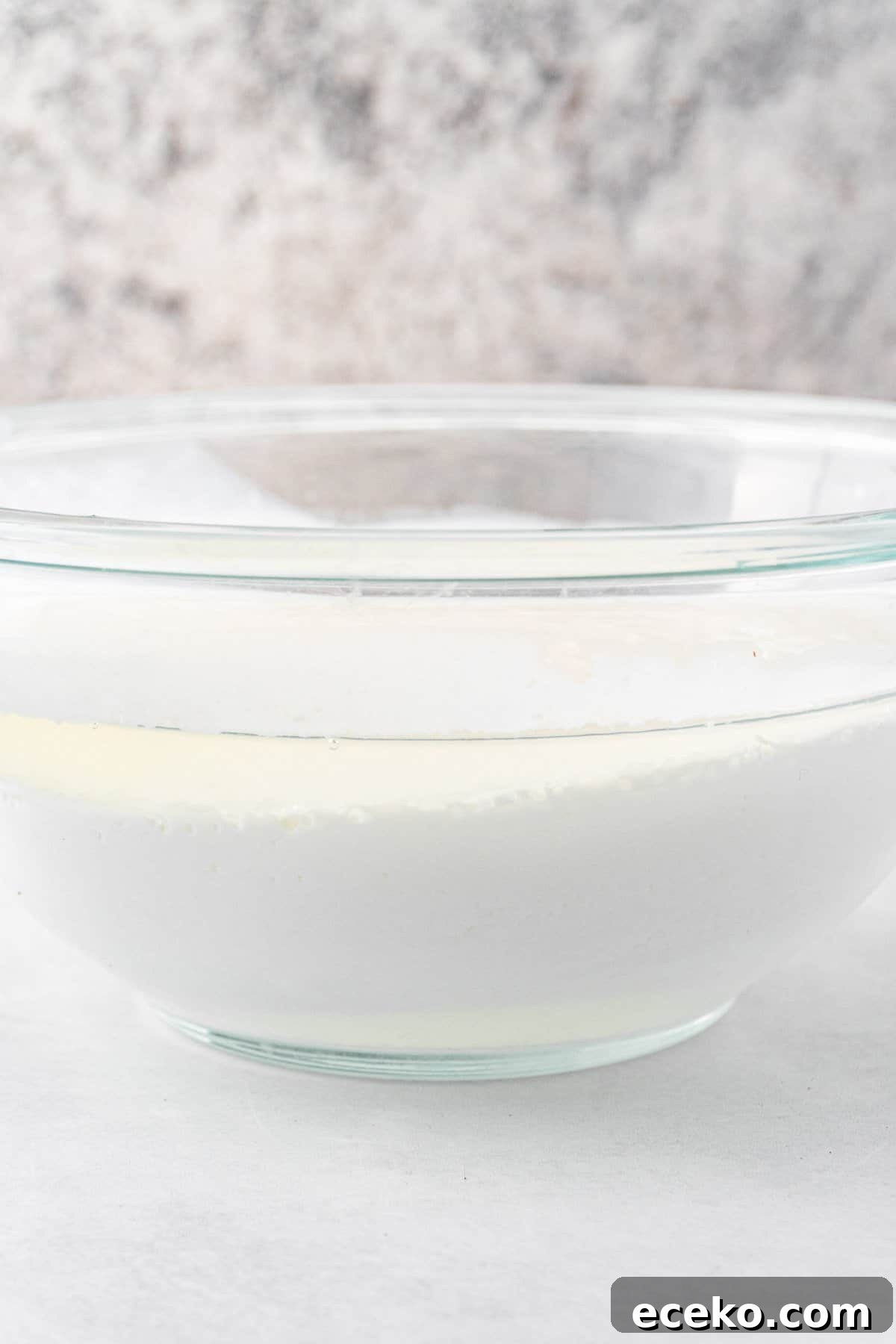 water and fat in buttermilk separated in glass bowl.