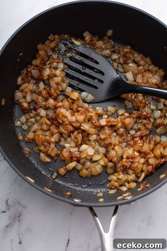 Creamy Homemade French Onion Dip Recipe for Parties 5 Caramelized onions in a skillet on a marble counter