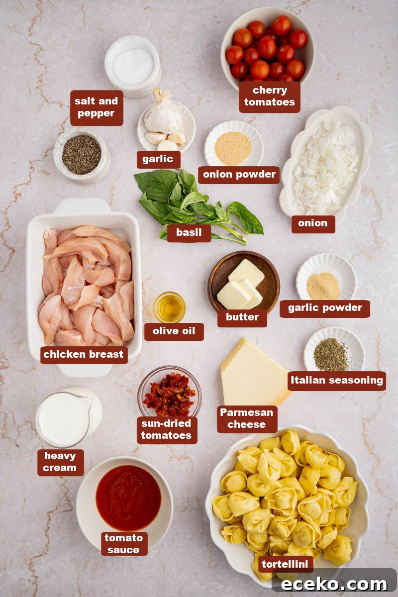 Creamy Chicken Tortellini Recipe with Garlic Parmesan Sauce 2 All of the ingredients for creamy chicken tortellini in bowls on a white countertop.