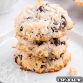 close up shot of Almond Joy Cookies stacked on top of each other