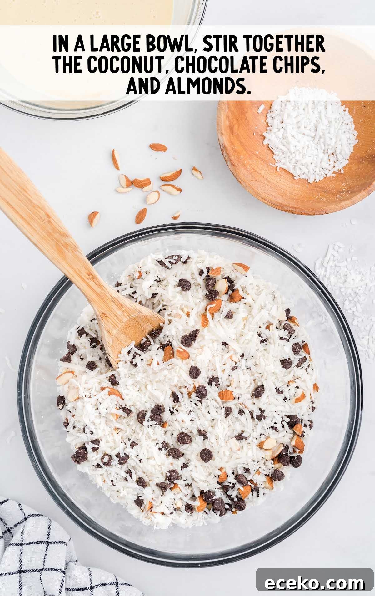 coconut, chocolate chips, and almonds folded together in a bowl
