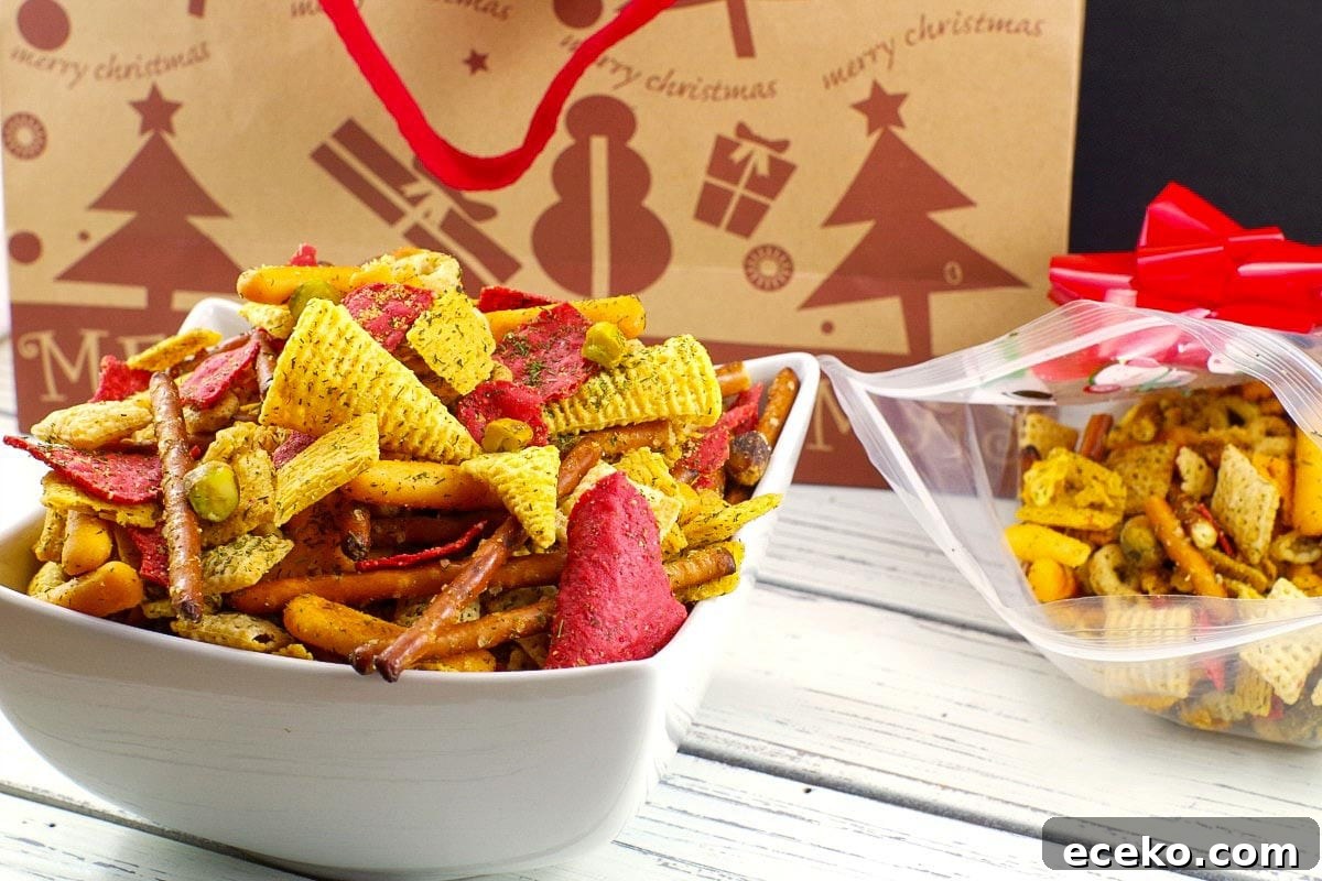 Christmas Chex Mix in a white bowl with a festive Christmas bag in the background
