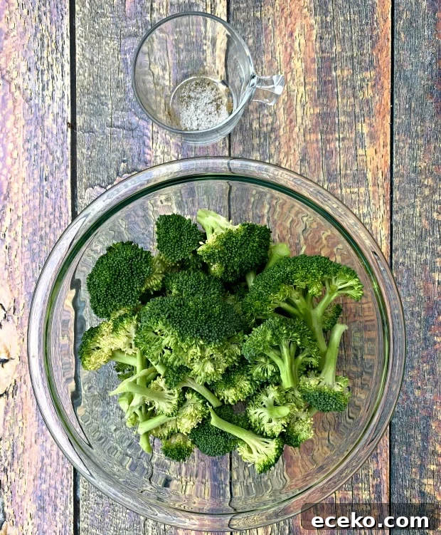 raw and cut broccoli in a glass bowl