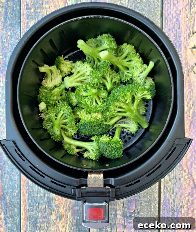 raw and cut broccoli in an air fryer