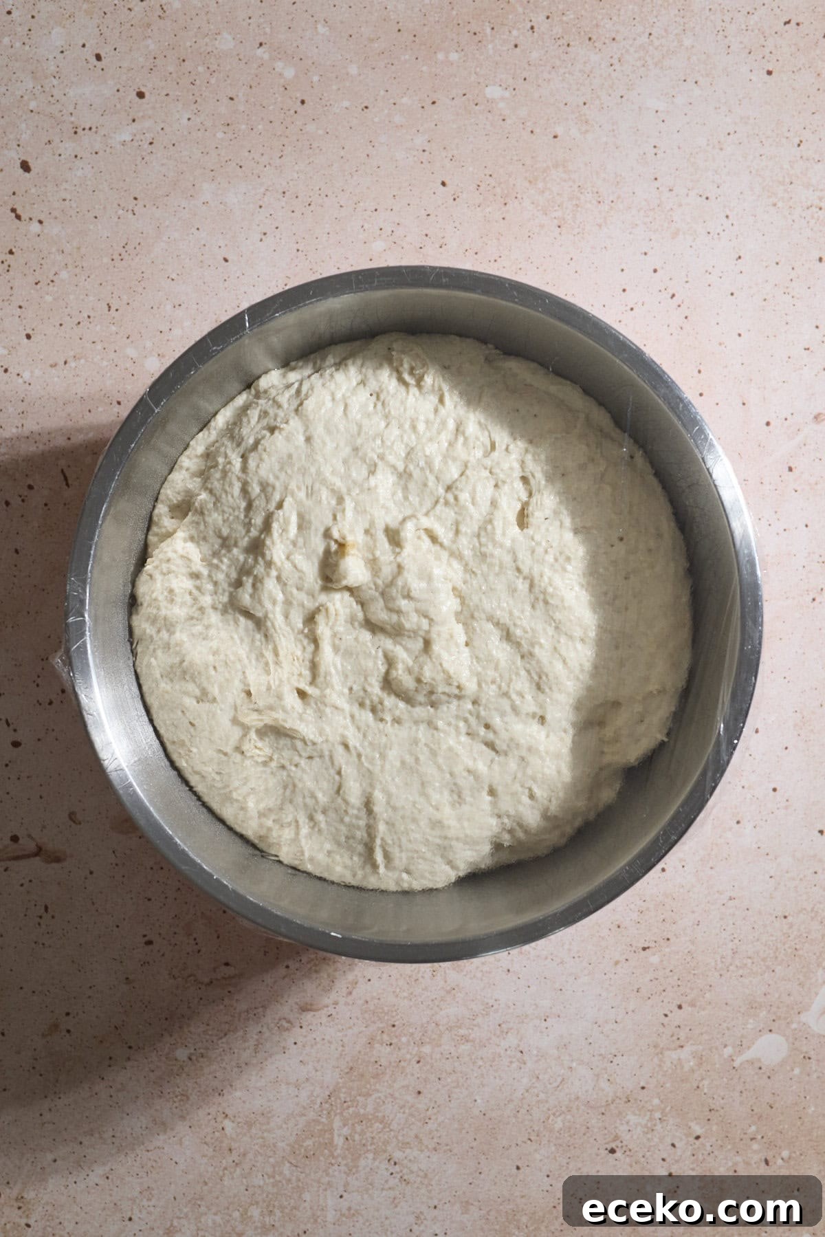Dough doubled in size in the rising bowl.