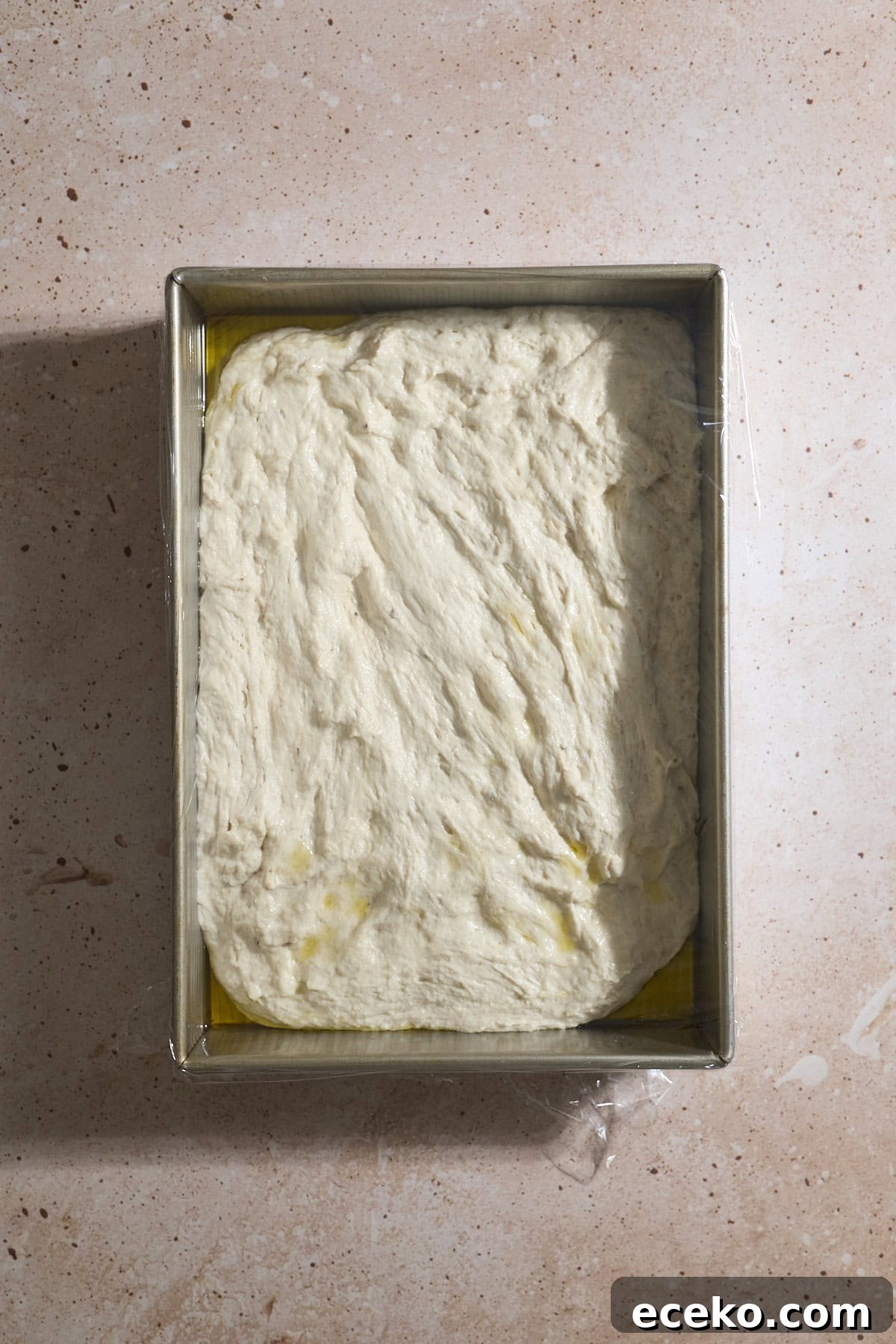 Dough spread to the edges in the baking pan.