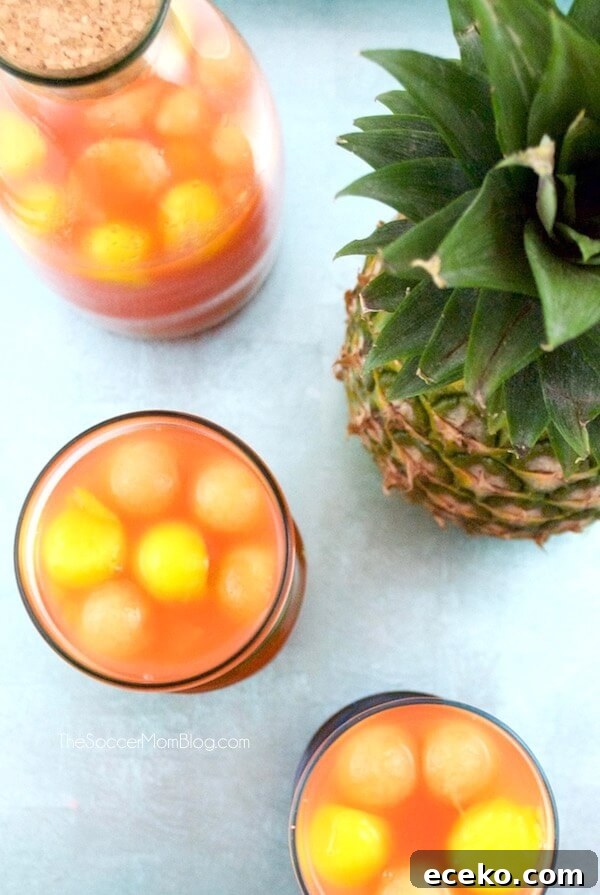The perfect summer party cocktail recipe: Tropical Rum Punch is like a vacation in your mouth! Easy, gorgeous, smooth, and fruity - it's a crowd pleaser!