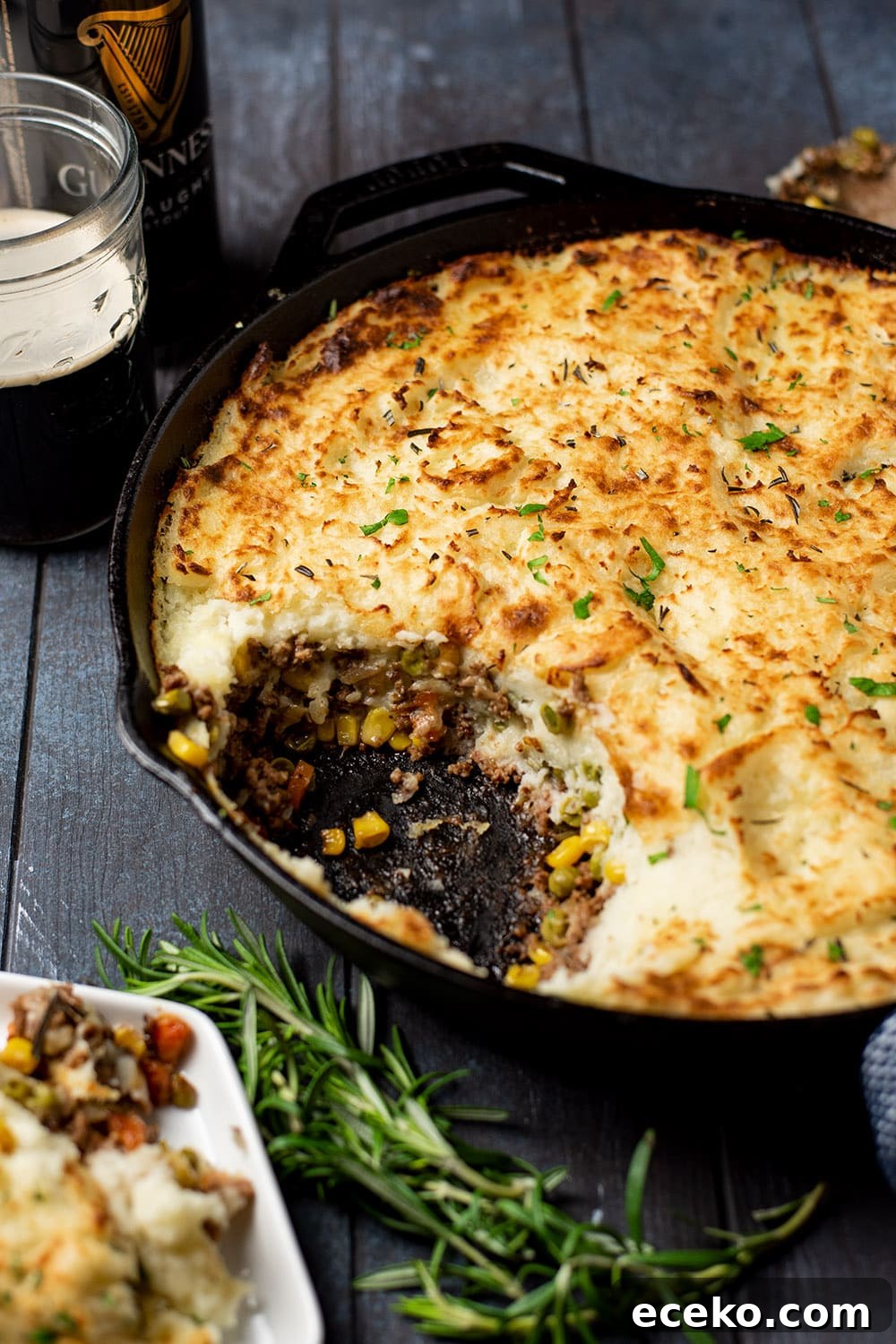 Skillet Shepherd’s Pie Recipe – One-Pan Comfort Dinner 3 Classic Shepherd's pie in a cast iron skillet with a scoop removed, revealing minced meat, carrots, corn, and a thick layer of golden mashed potatoes.