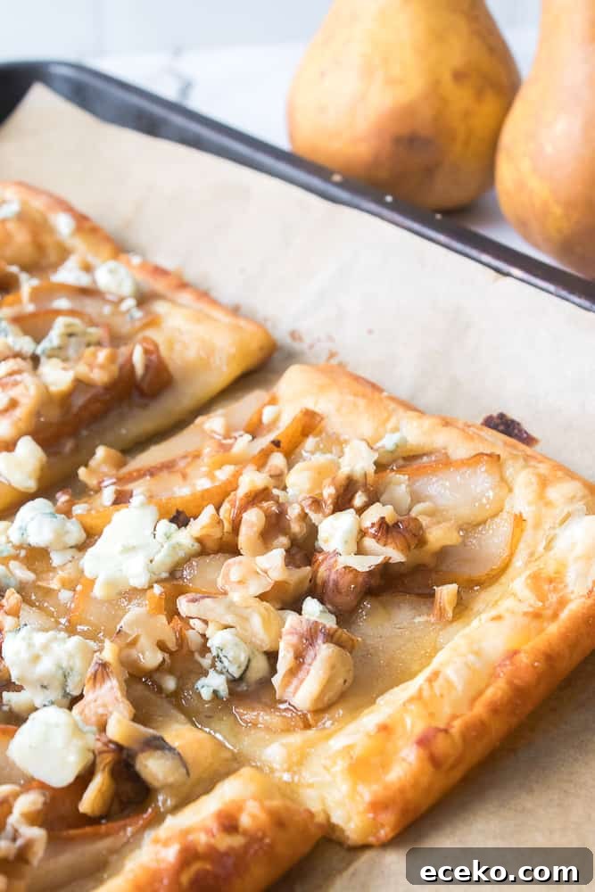 Caramelized Pear & Blue Cheese Tartlets for Entertaining 11 close up vertical shot of pear and blue cheese tartlet