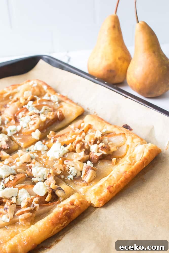 Caramelized Pear & Blue Cheese Tartlets for Entertaining 3 blue cheese and pear tart on baking sheet with two pears in background