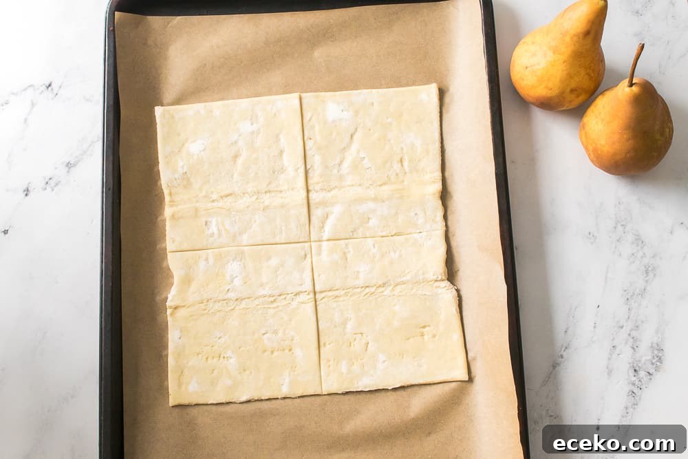 Caramelized Pear & Blue Cheese Tartlets for Entertaining 7 puff pastry on baking sheet cut into four squares