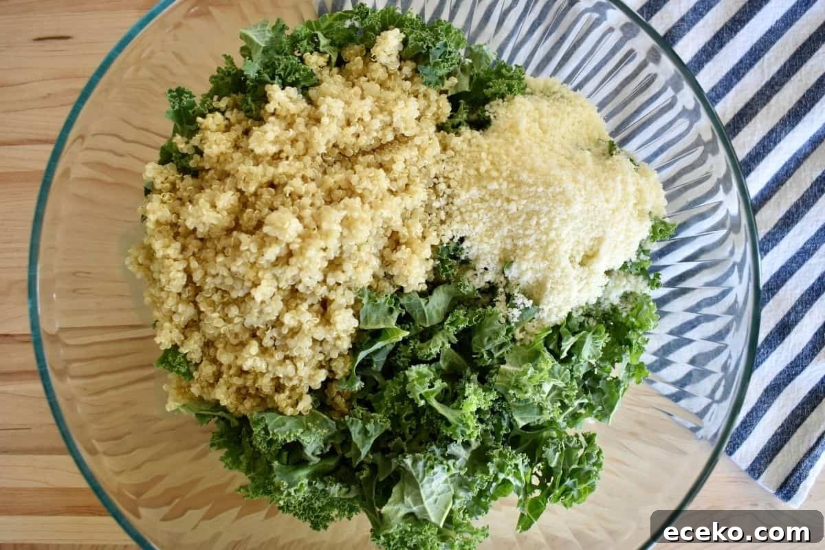Glass bowl with kale, quinoa, and parmesan cheese.