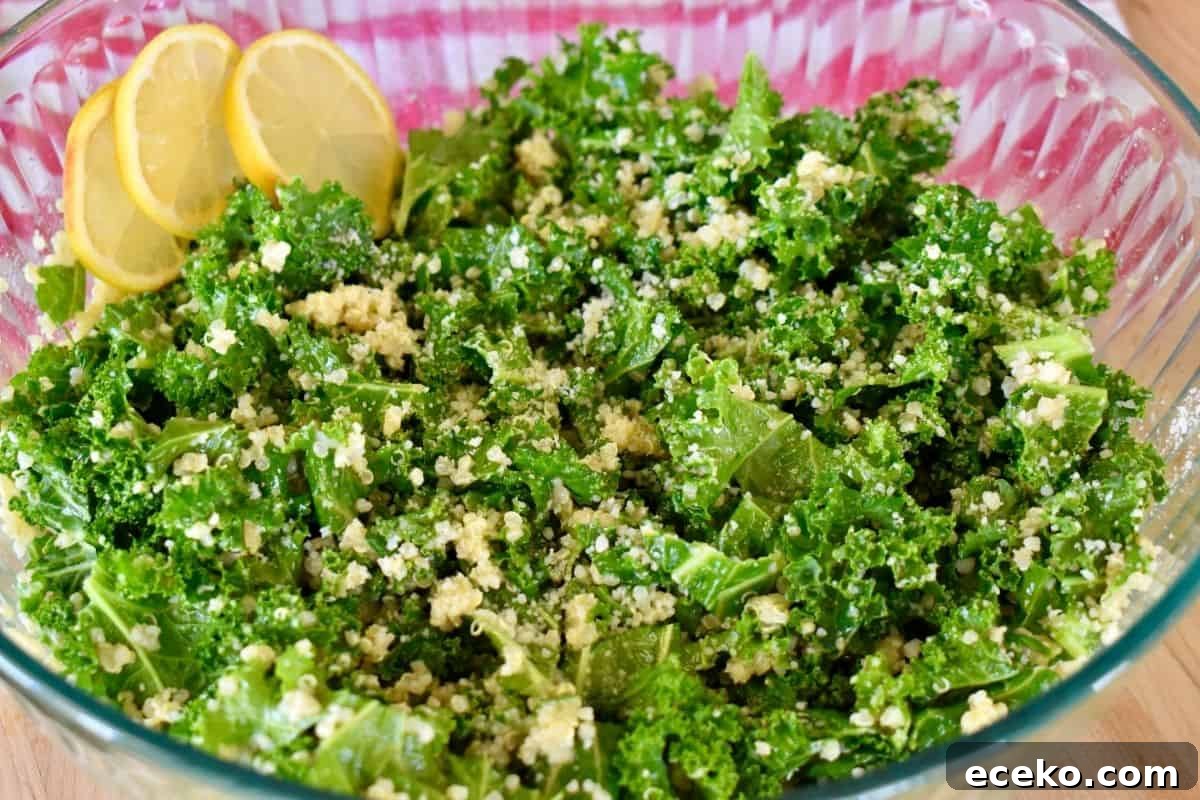 Kale Quinoa Salad with lemon vinaigrette in a glass bowl.