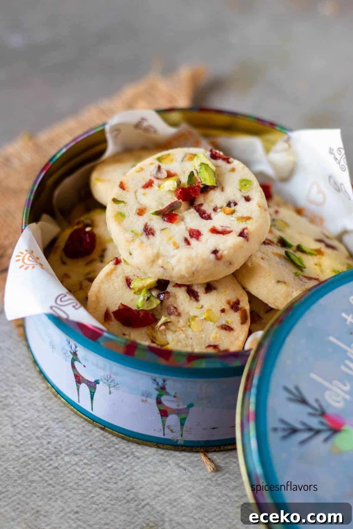 Cranberry Pistachio shortbread cookies placed in a cookie tin