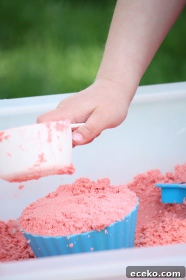child scooping coloured cloud dough