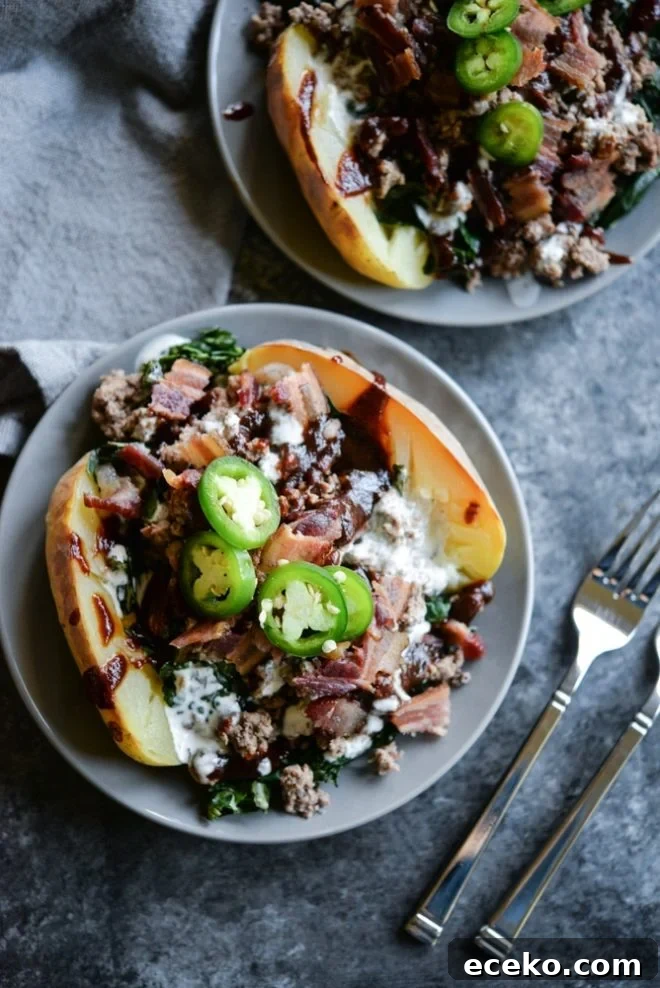 BBQ Bacon Burger Stuffed Meal-Prep Potatoes 3 overhead view of meal prep bbq bacon burger loaded potatoes on a plate topped with jalapenos