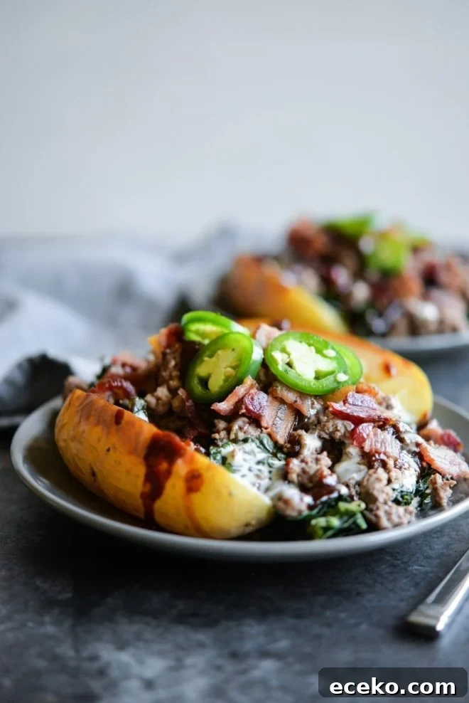 BBQ Bacon Burger Stuffed Meal-Prep Potatoes 4 meal prep bbq bacon burger loaded potatoes on a plate topped with jalapenos