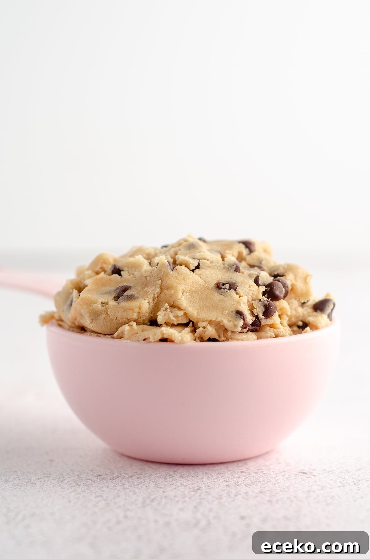 Cookie Dough Stuffed Brownies: Decadent Chocolate Dessert Recipe 11 cookie dough in a pink measuring cup
