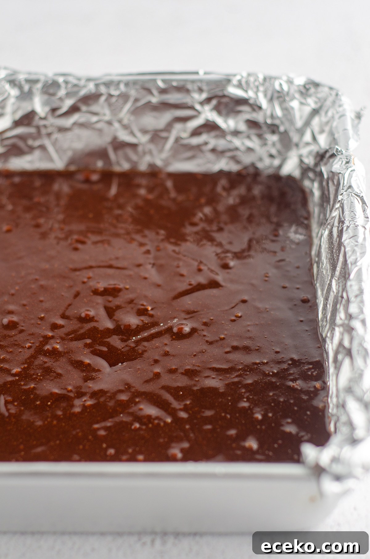 Cookie Dough Stuffed Brownies: Decadent Chocolate Dessert Recipe 6 brownie batter in a pan lined with foil