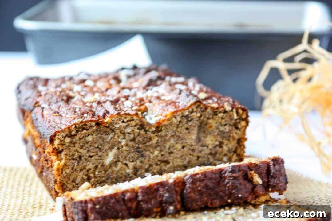 A close up of a slice of banana loaf with coconut