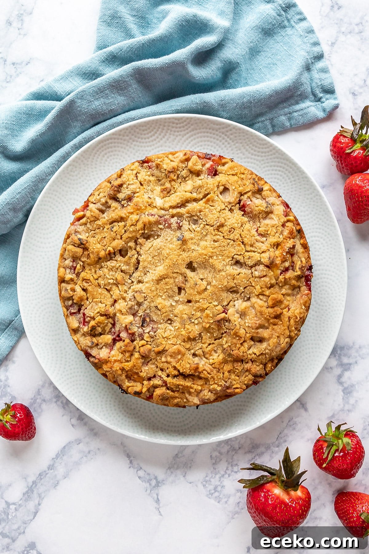 Strawberry Shortcake Crumb Cake Recipe — Moist Summer Dessert 3 An overhead image of a strawberry crumb cake showing the streusel topping.
