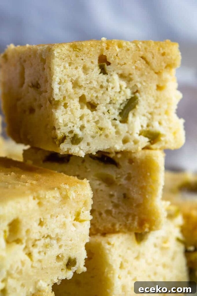 Spicy Vegan Jalapeño Cornbread Recipe 4 an uneven tower of pale gold cornbread with green bits