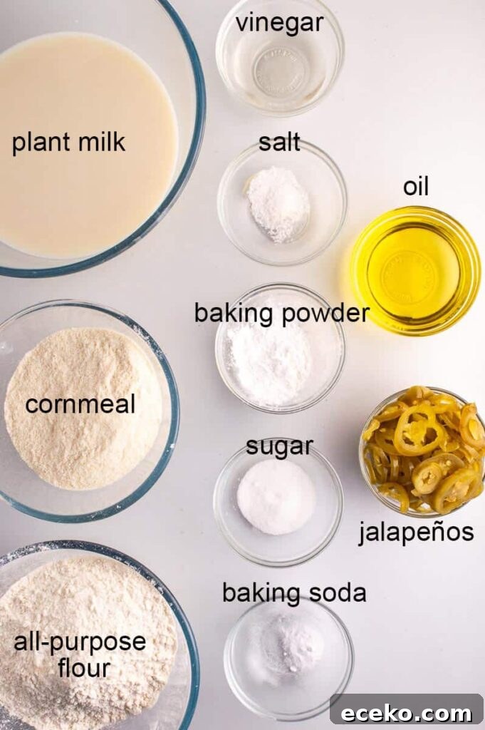Spicy Vegan Jalapeño Cornbread Recipe 5 labelled ingredients including flour, plant milk, cornmeal, baking powder, salt, sugar, vinegar, oil and jalapeños