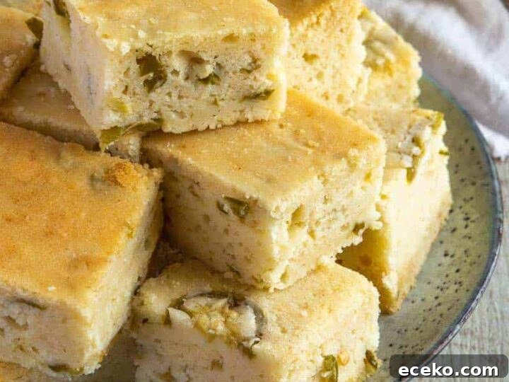 A plate of pale gold cornbread speckled with diced jalapeños