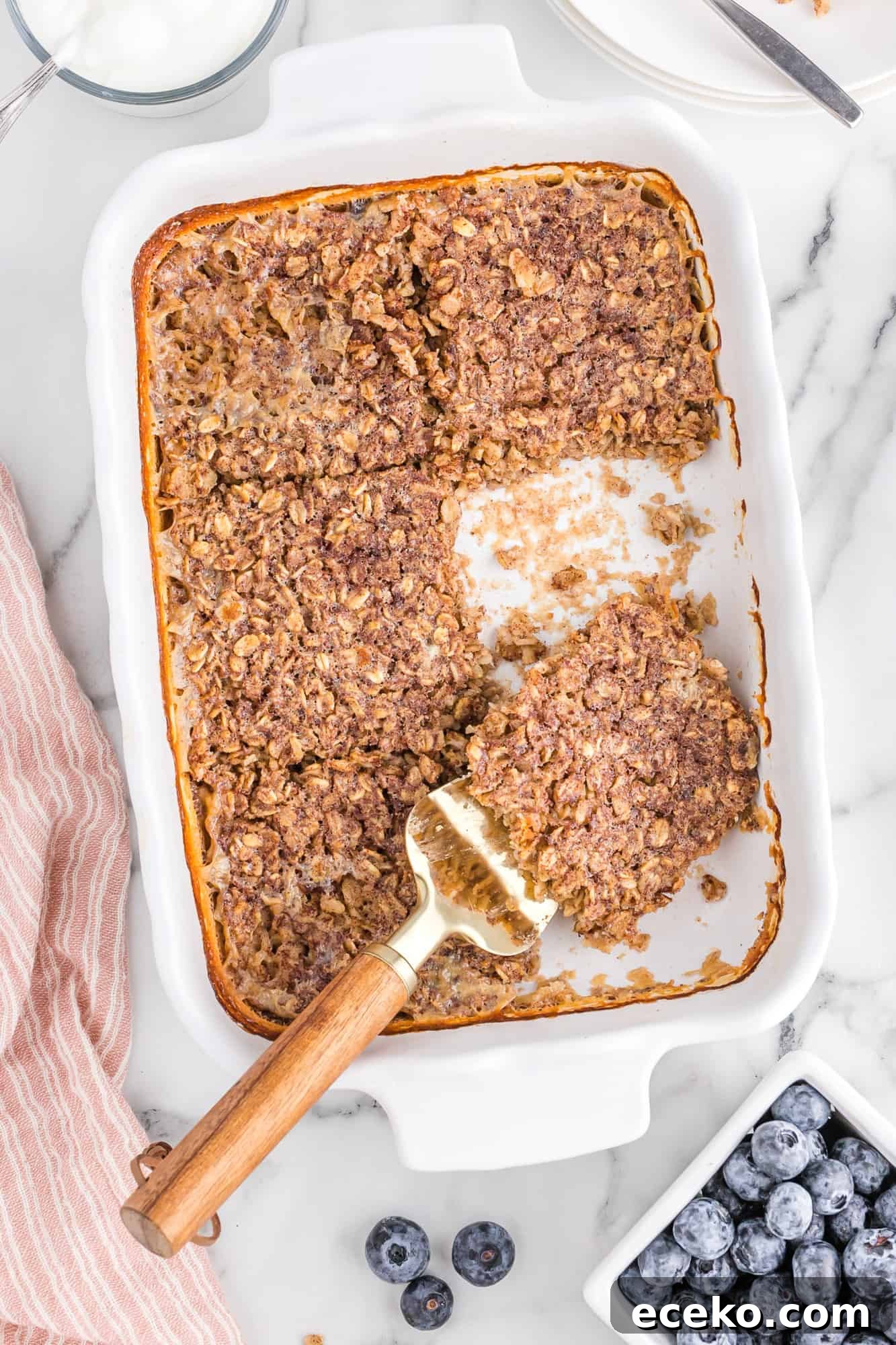 Baked Oatmeal Recipe with Flavor Ideas and Variations 3 Square of baked oatmeal being removed from baking dish.