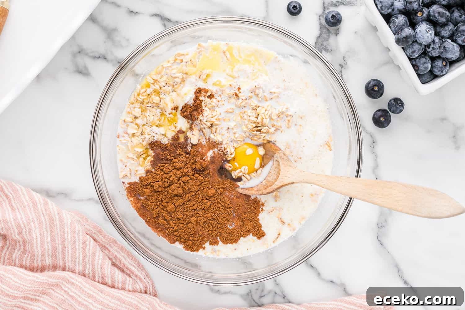 Baked Oatmeal Recipe with Flavor Ideas and Variations 5 Unmixed ingredients in a clear glass bowl.
