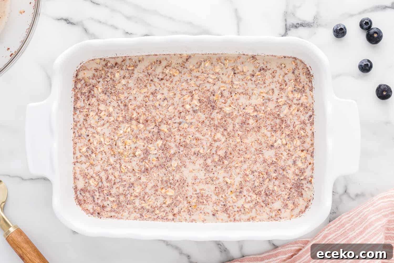 Baked Oatmeal Recipe with Flavor Ideas and Variations 6 Unbaked oatmeal in a white casserole dish.