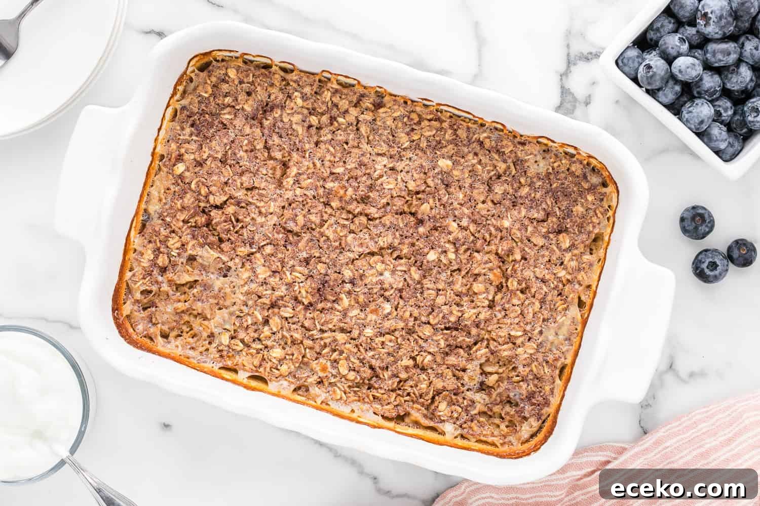 Baked Oatmeal Recipe with Flavor Ideas and Variations 7 Baked oatmeal, uncut, in a white casserole dish.